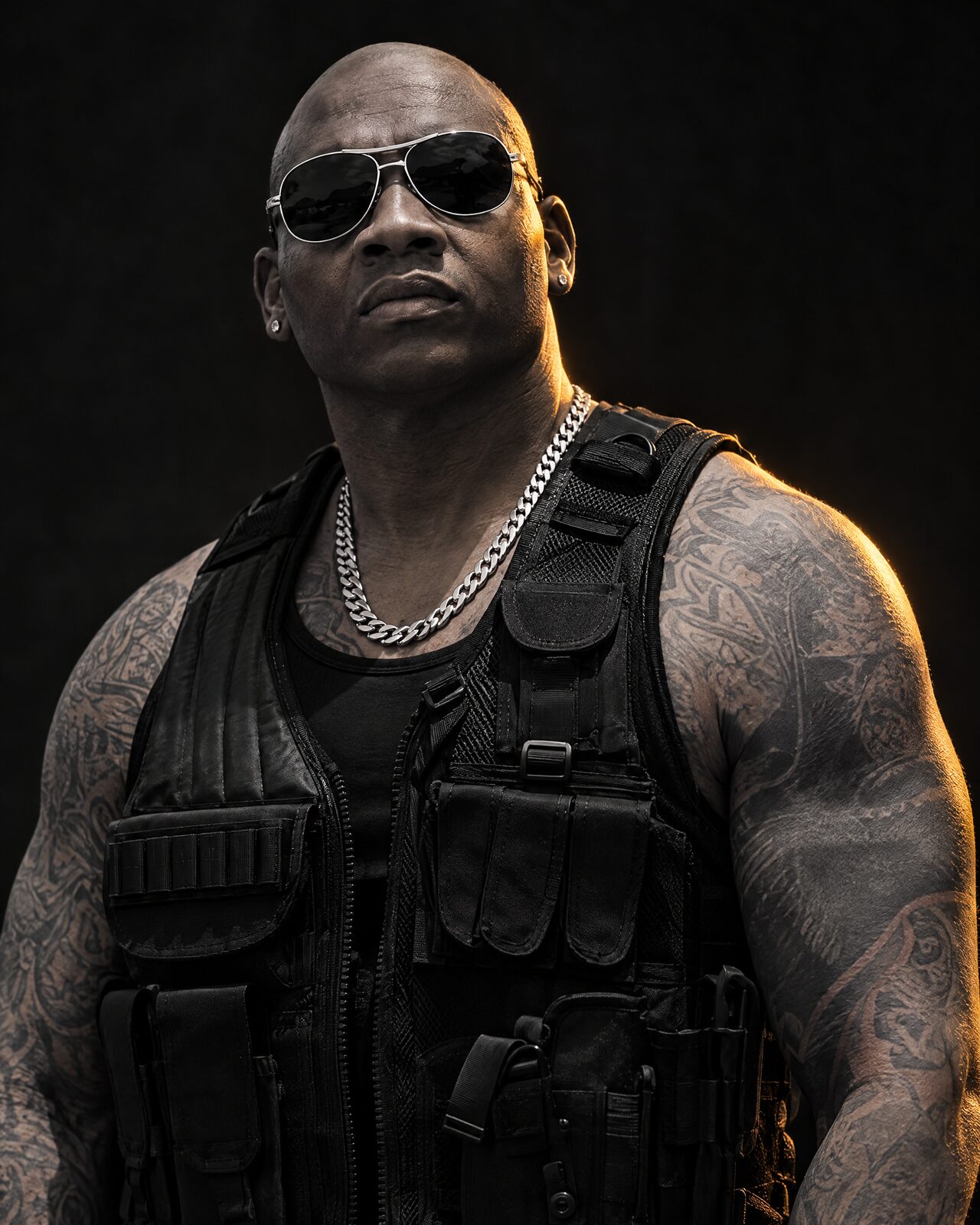 Black-and-white portrait of The People's Bouncer with gold rim light
